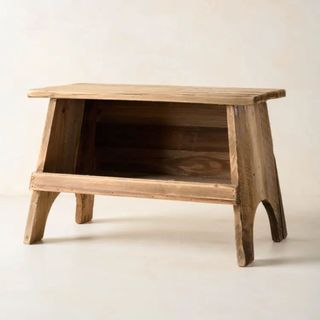 A wooden gardening stool from magnolia - there is a small shelf under the main stool
