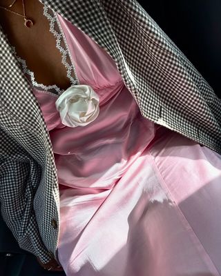 Powder pink outfits: Pink dress with white flower and blazer