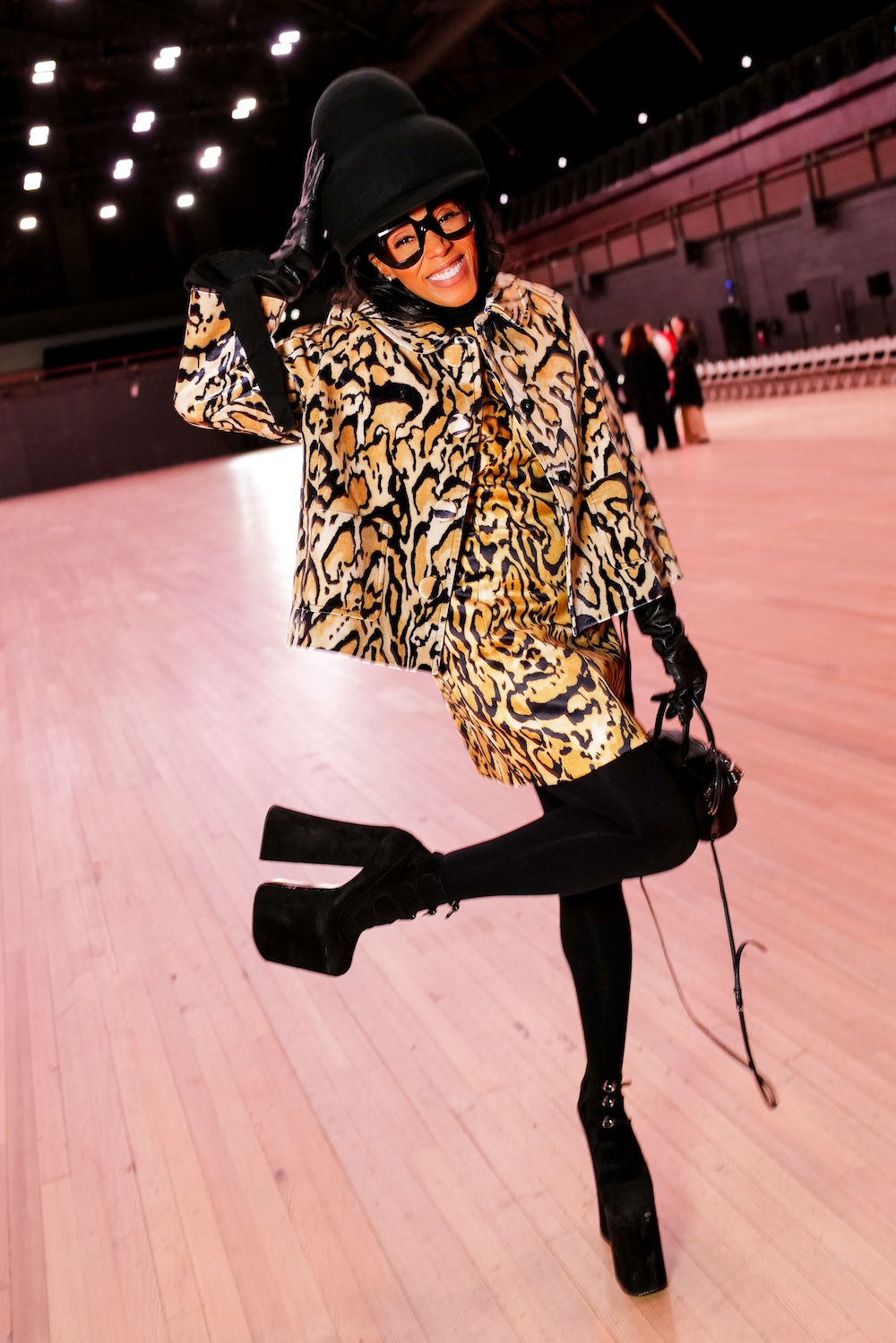 June Ambrose posing in a leopard-print matching set with black platform shoes at the Marc Jacobs spring 2026 fashion show during NYFW.