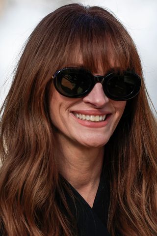 Julia Roberts is pictured with dark copper hair whilst arriving for the Jacquemus Womenswear Ready-to-wear Spring-Summer 2024 collection at Maeght Foundation, in Saint-Paul-de-Vence, southern France, on January 29, 2024.