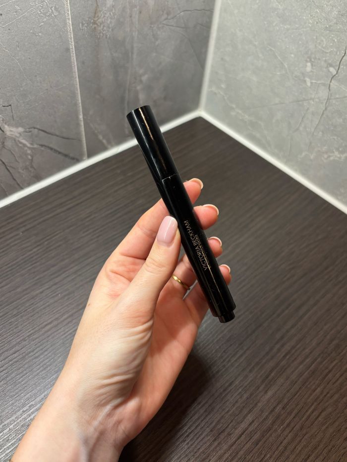 Deputy beauty editor Grace Lindsay holding a Victoria Beckham Beauty concealer