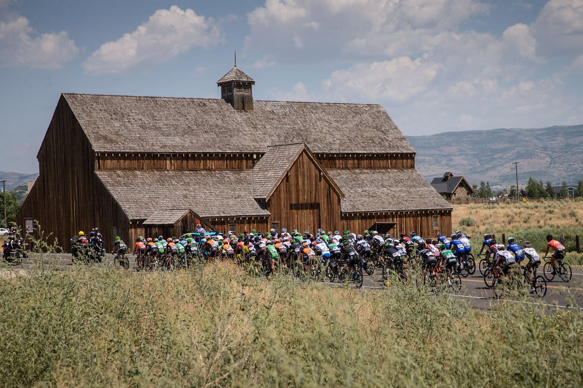 The peloton passes a barn near the start of stage 6 at the Tour of Utah