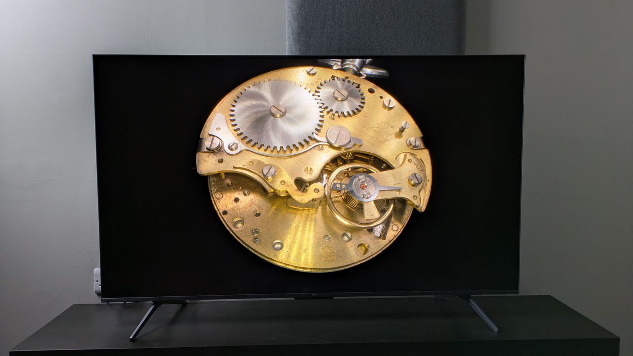 TCL C6K with gold pocket watch on screen