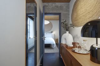 hotel bedroom lobby with natural wood texture console and warm lamp light