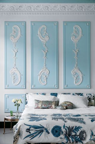 Blue and white panelling in a bedroom disguising storage
