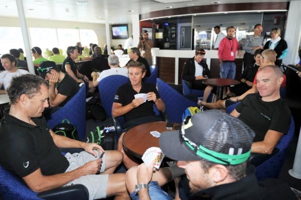 Racers play cards on the ferry on the way to stage 2