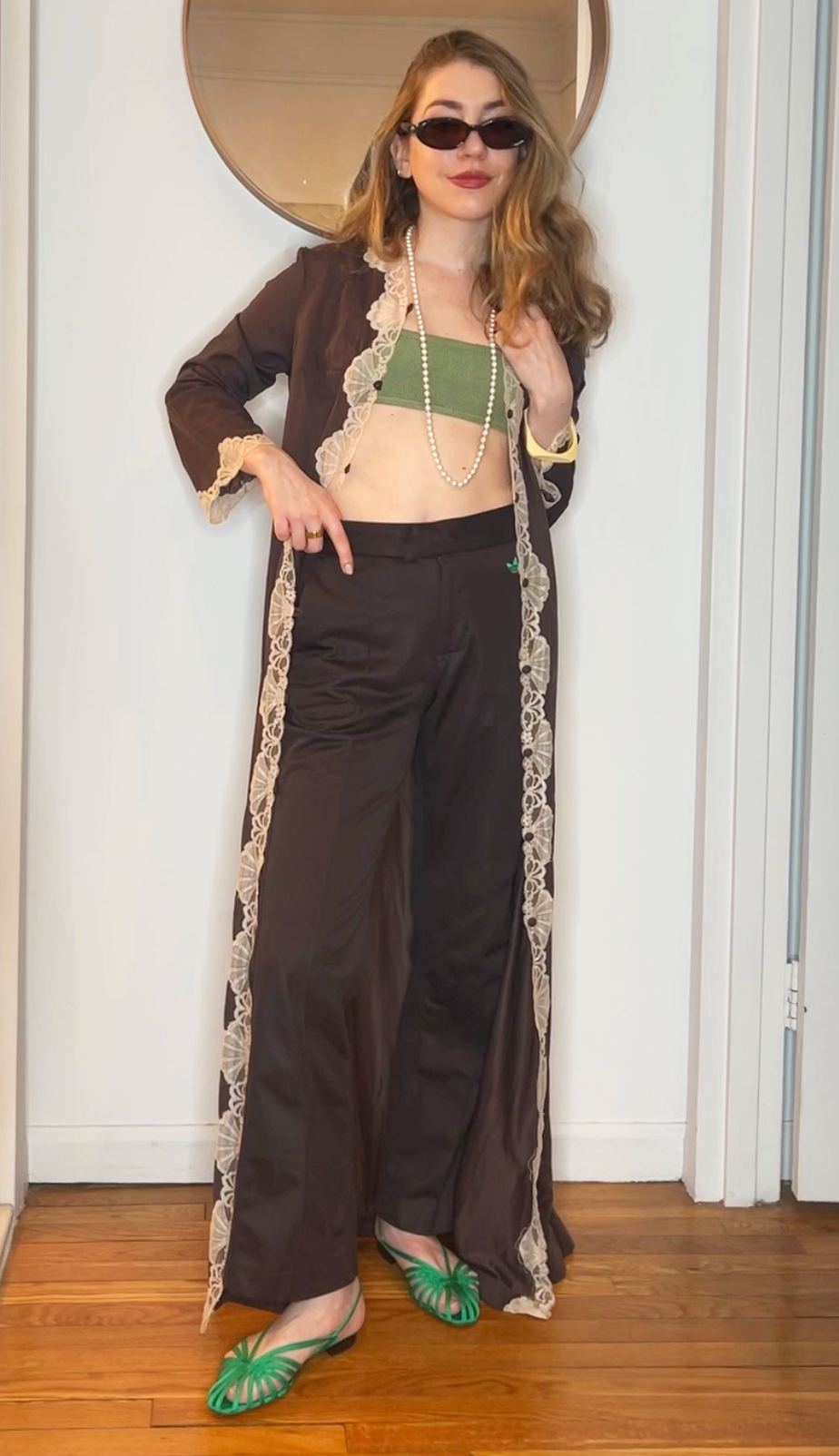 Elizabeth Cardinal Tamkin wears "pop of green" sandals and a bandeau with an earth-toned duster and pants