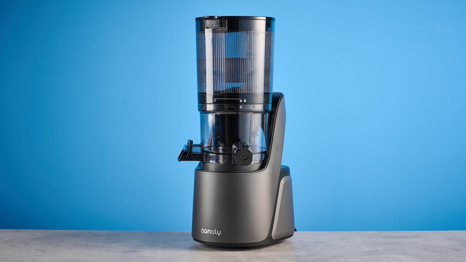 Canoly C16 Cold Press Juicer photographed in front of a blue background