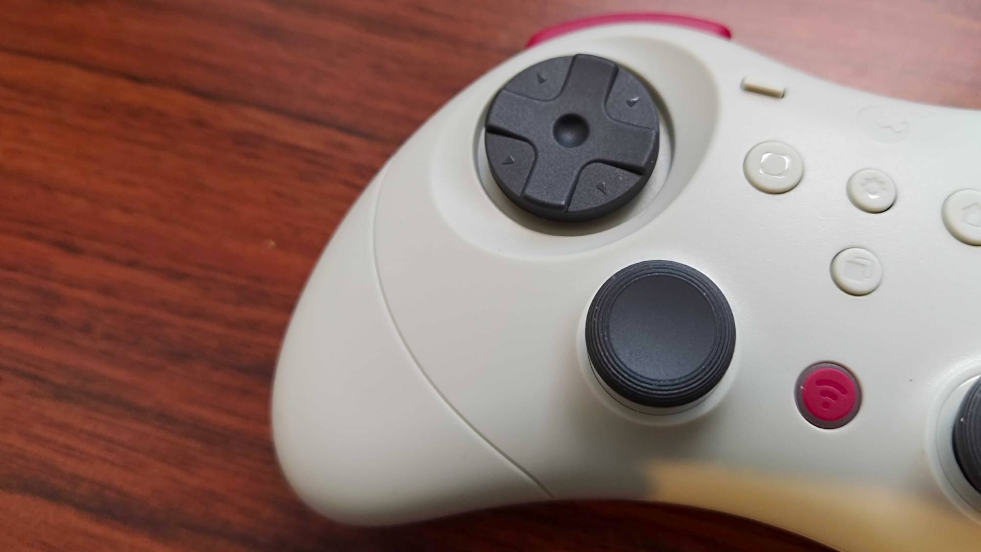 Close up of Gulikit Elves 2 Pro D-pad on woodgrain desk.