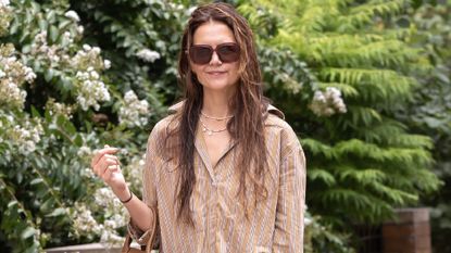 katie holmes walks around manhattan wearing pearl necklaces, a button down, and wet hair