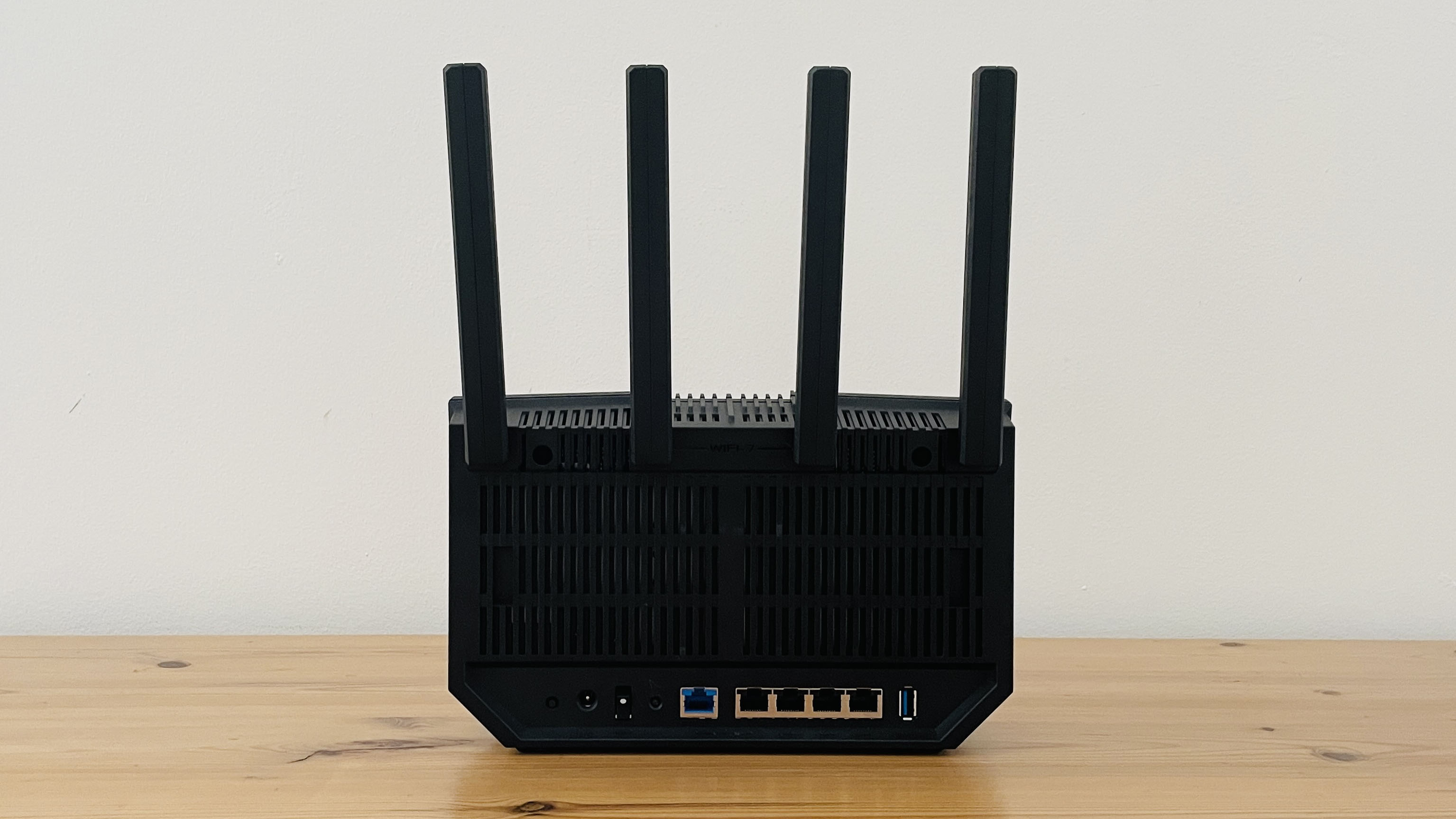 Asus RT-BE92U router on wooden table