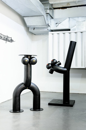 Two black tables in the shape of bodies
