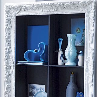 white wall with frame and pot