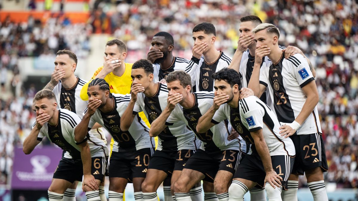 Germany players protest against FIFA by covering their mouths ahead of their 2022 World Cup group match against Japan in Qatar