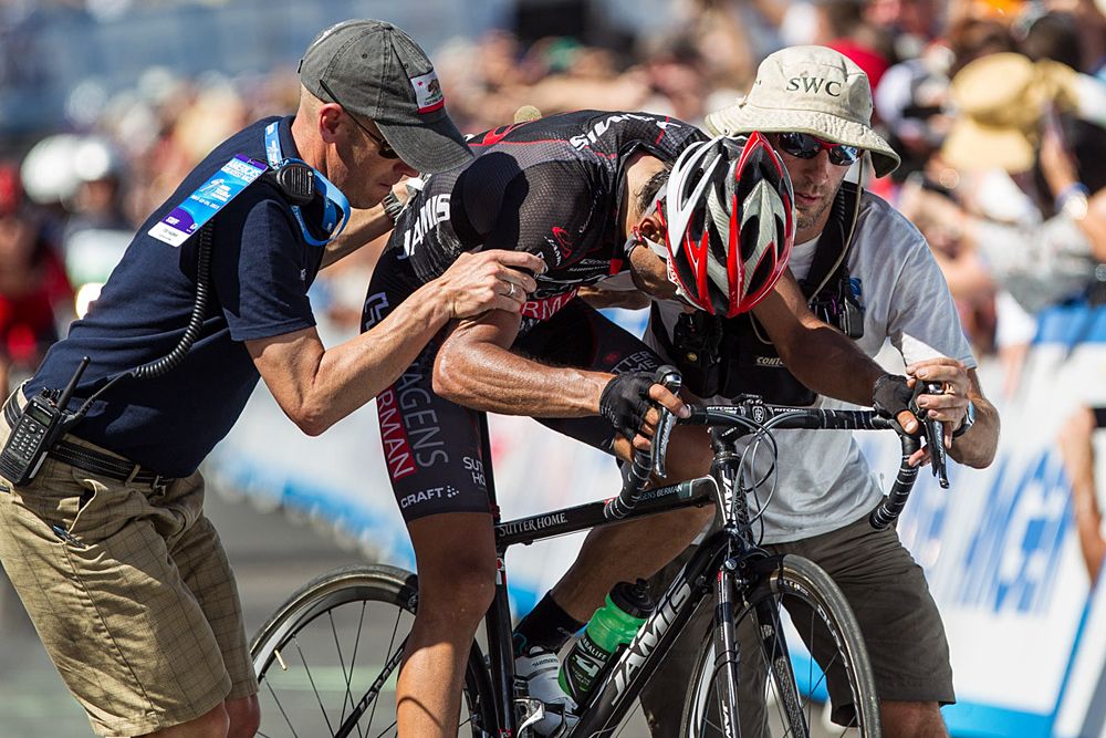 Janier Acevedo (Jamis) is helped after winning in the blistering heat