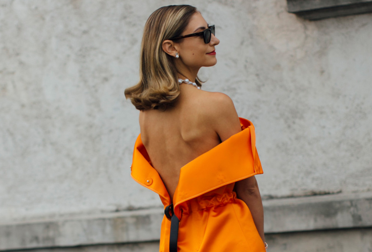 Jenny Walton wearing an orange double-satin Prada dress during Milan Fashion Week.