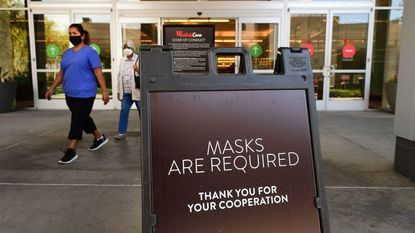 A sign asking people to wear masks inside the building.