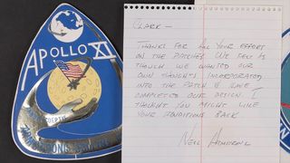 a blue and yellow gumdrop-shaped emblem and a handwritten note on a white lined piece of notebook paper