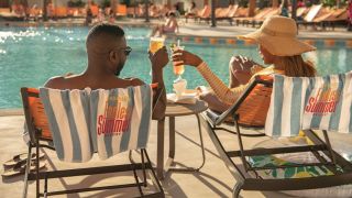 Two people try Endless Summer's original cocktails by the pool. 