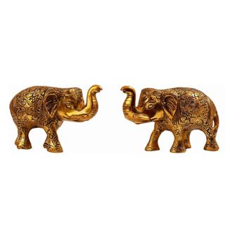Two gold metal elephant decorations facing each other