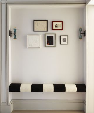 Modern entryway bench ideas with a black and white striped floating bench inside an alcove