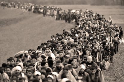 Refugees are escorted through Slovenia.