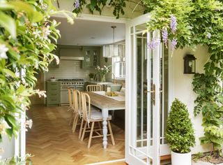 View through backdoors into a green kitchen