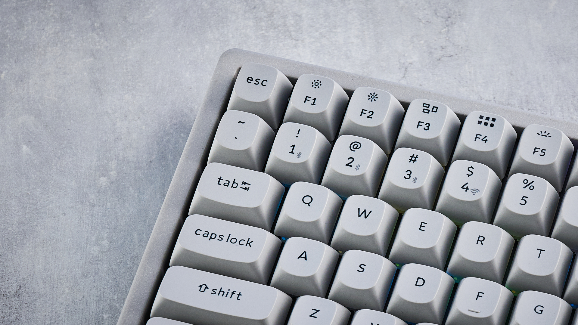 The Keychron K2 HE in concrete, on a stone surface.