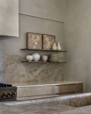 a neutral kitchen with a beige marble backsplash