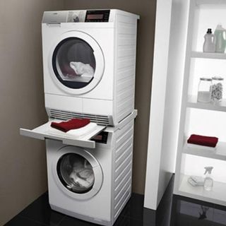 utility room with washing machines and white shelves