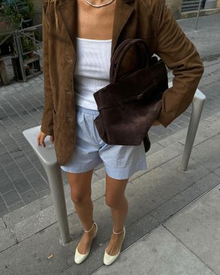 woman. in suede jacket and bag