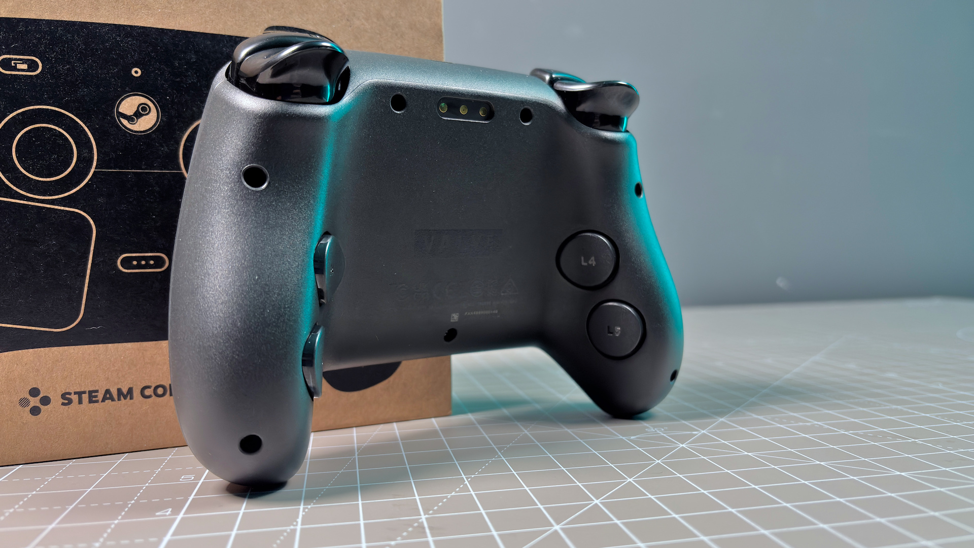 The Steam Controller on a desk during a teardown, with various parts removed.