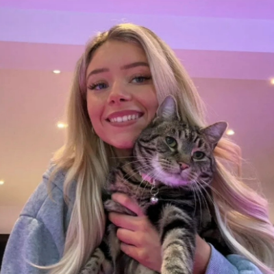 Megan holding her cat Nala and smiling