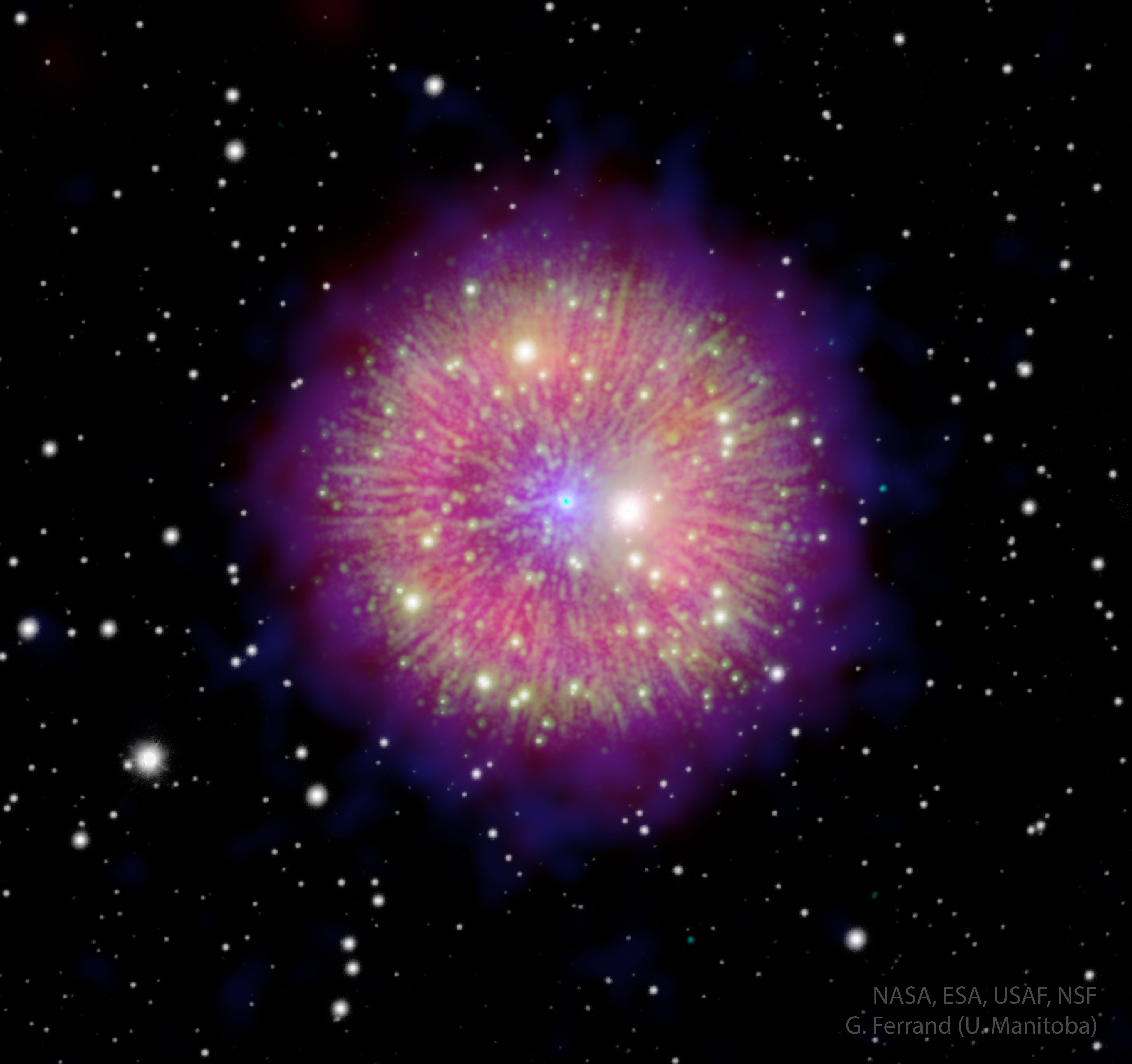 a small, bright blue central dot erupts with rays of brilliant pink and yellow-green, with shining stars dispersed within as well as around in the black of space.
