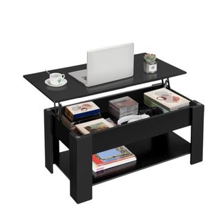 A black lift-top coffee table with papers and decor on top of it and in it