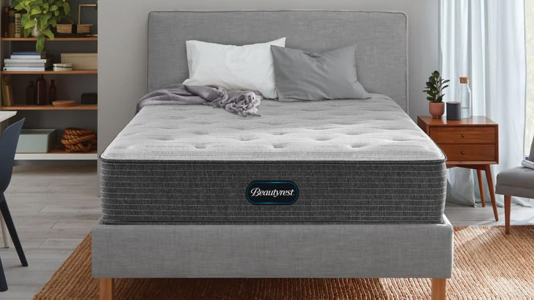 The Beautyrest Select Mattress on a grey fabric bedframe placed on a jute rug