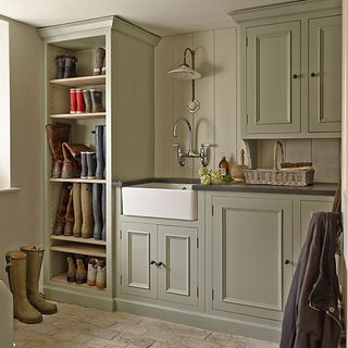 boot room with bespoke green cupboards