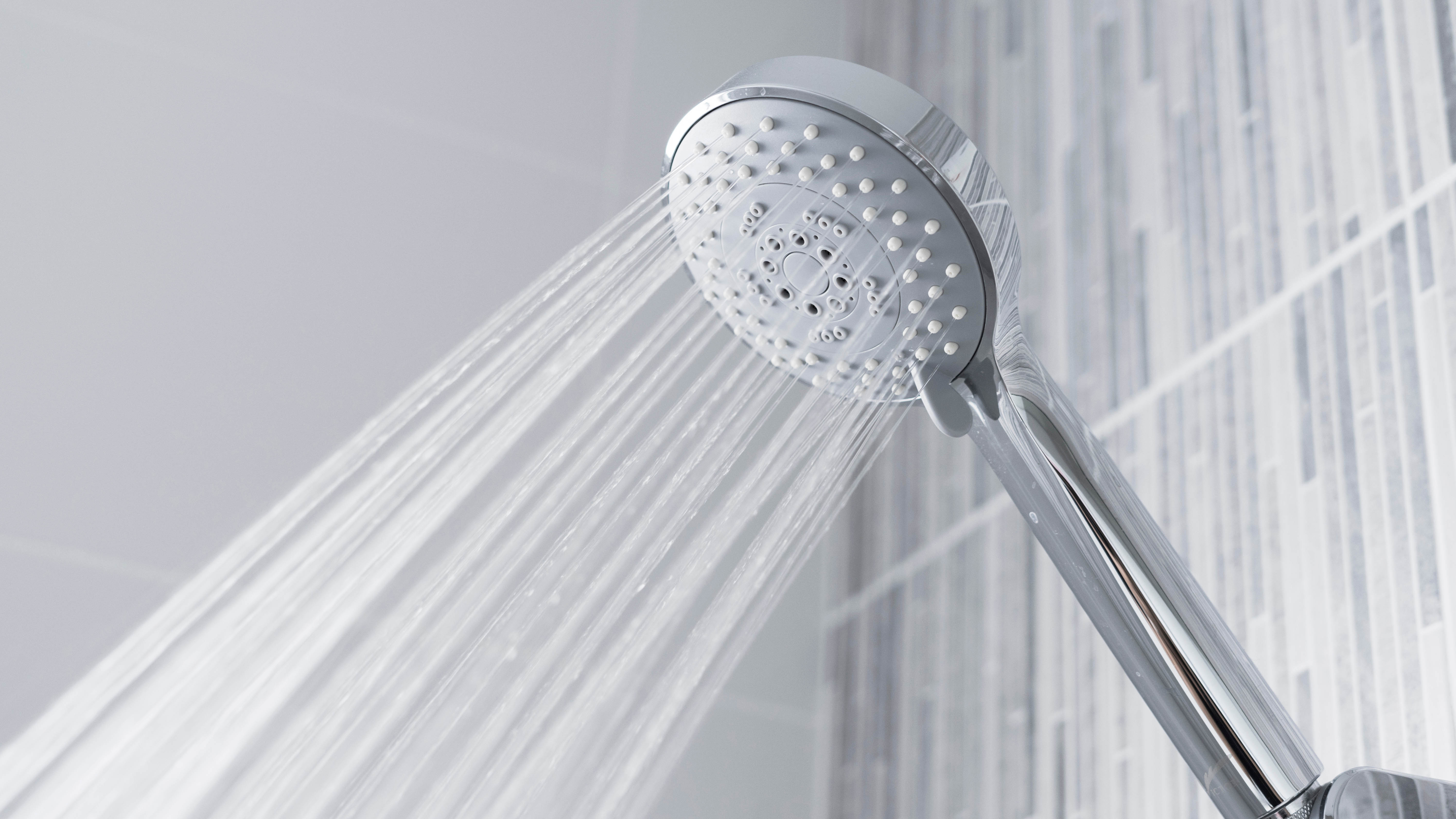 A shower head running water