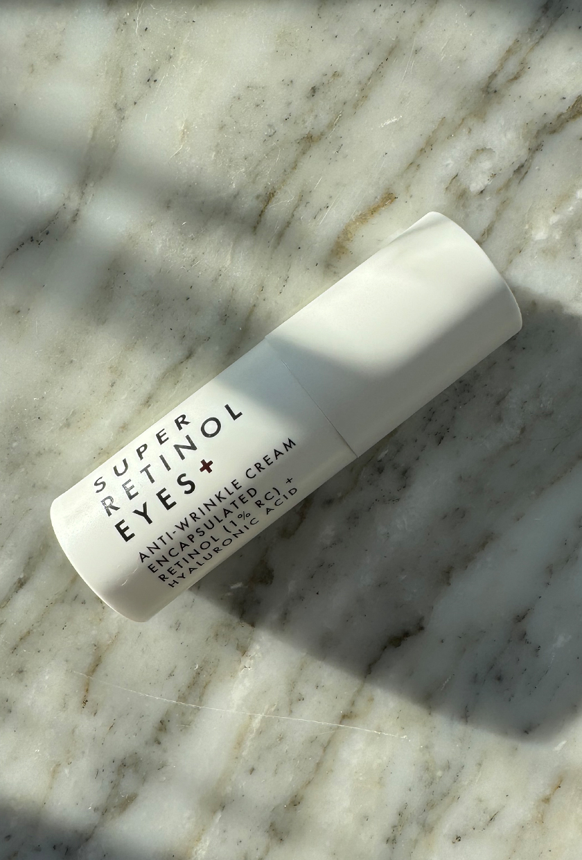Beauty Pie Retinol eye cream on marble table