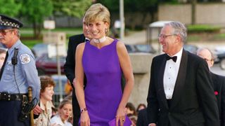 Diana stepping out in Chicago in a vibrant purple dress next to a man in black tie
