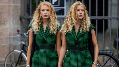 Twins wearing green black checkered sleeveless jacket outside Baum und Pferdgarten during the Copenhagen Fashion Week Spring/Summer 2024 on August 09, 2023 in Copenhagen, Denmark.