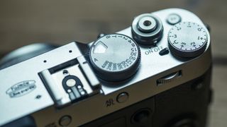 You can use your camera's exposure compensation dial to correct for your camera's metering