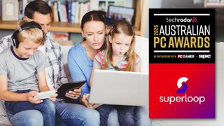 Family of 4 sitting on a sofa using connected devices.