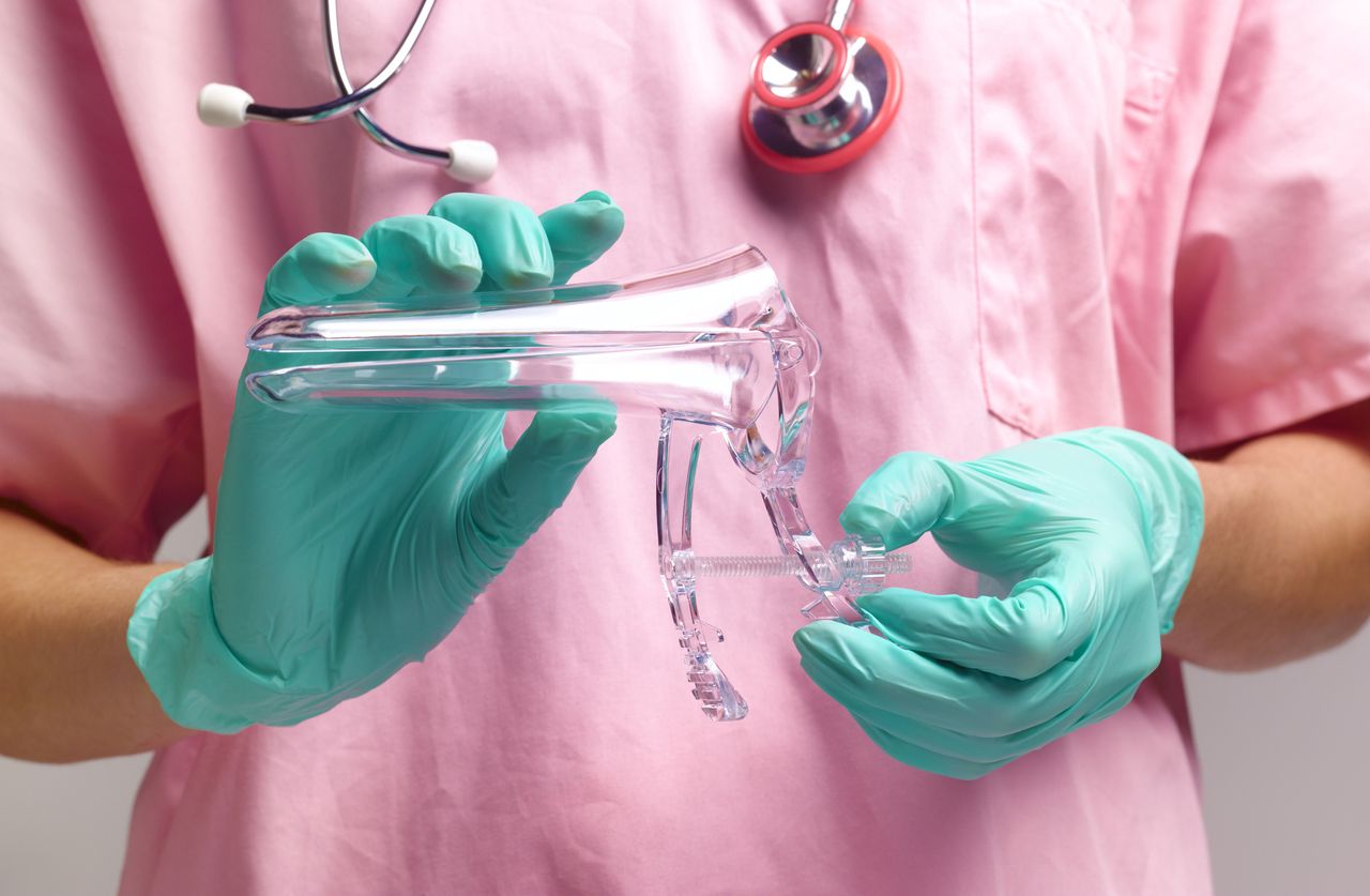 Gynaecologist holding vaginal speculum for a smear test