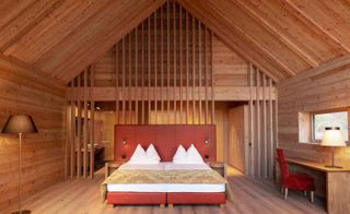 Large guestroom with wood panel walls & high ceiling