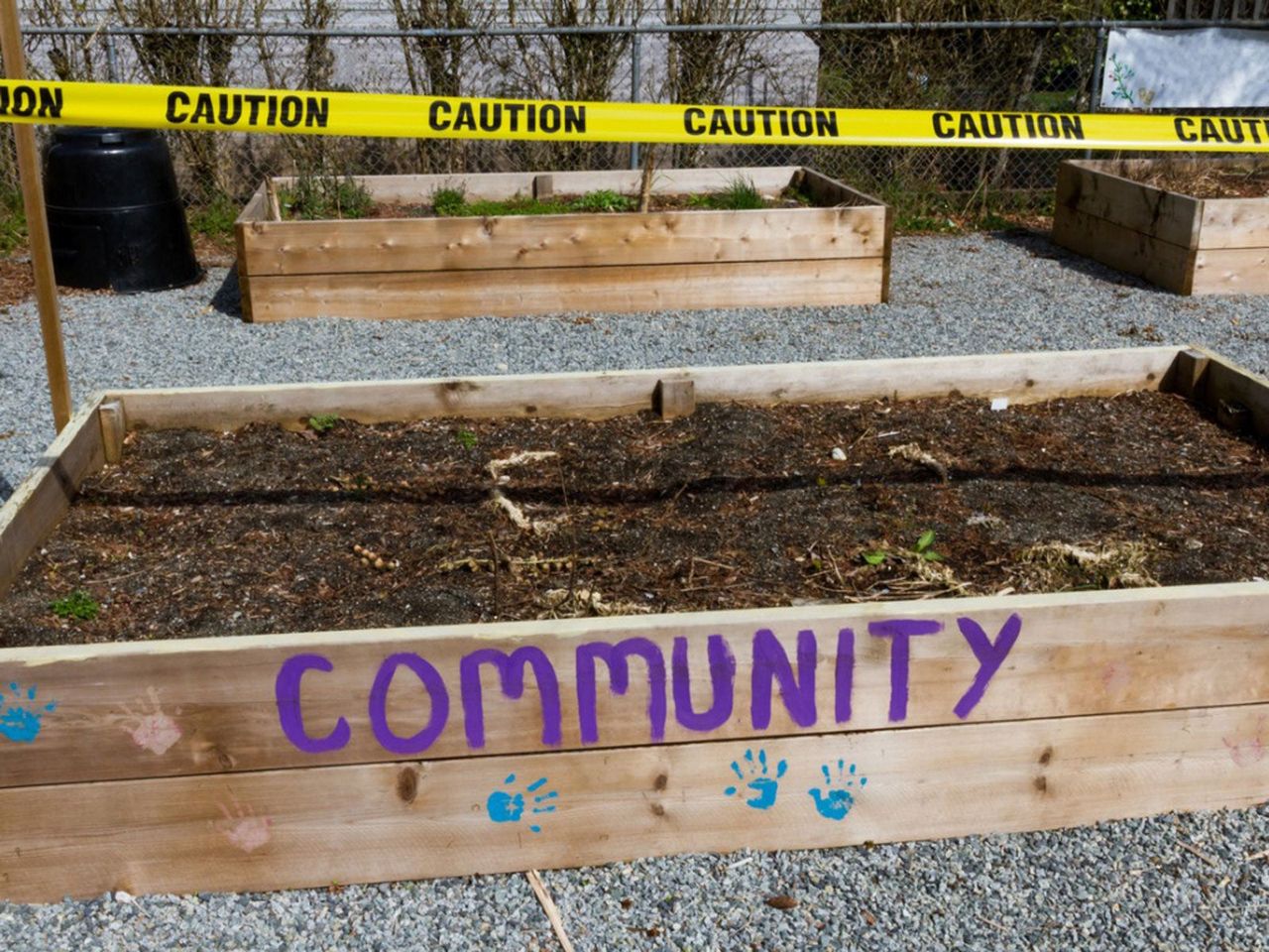 Community Garden With Yellow Caution Tape Across Garden Box