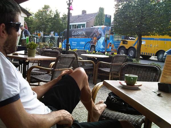 Kiwi Guy and I sit drinking a cappuccino watching our team bus being towed away by a possible Transformer.