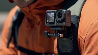 DJI Osmo Action 4 Action Camera being worn on a hiker's shoulder strap