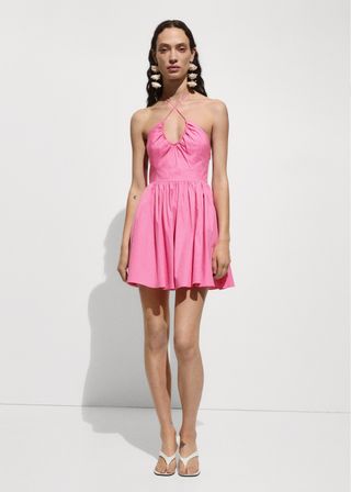 The model wore a bubblegum pink cotton dress with a plunging neckline