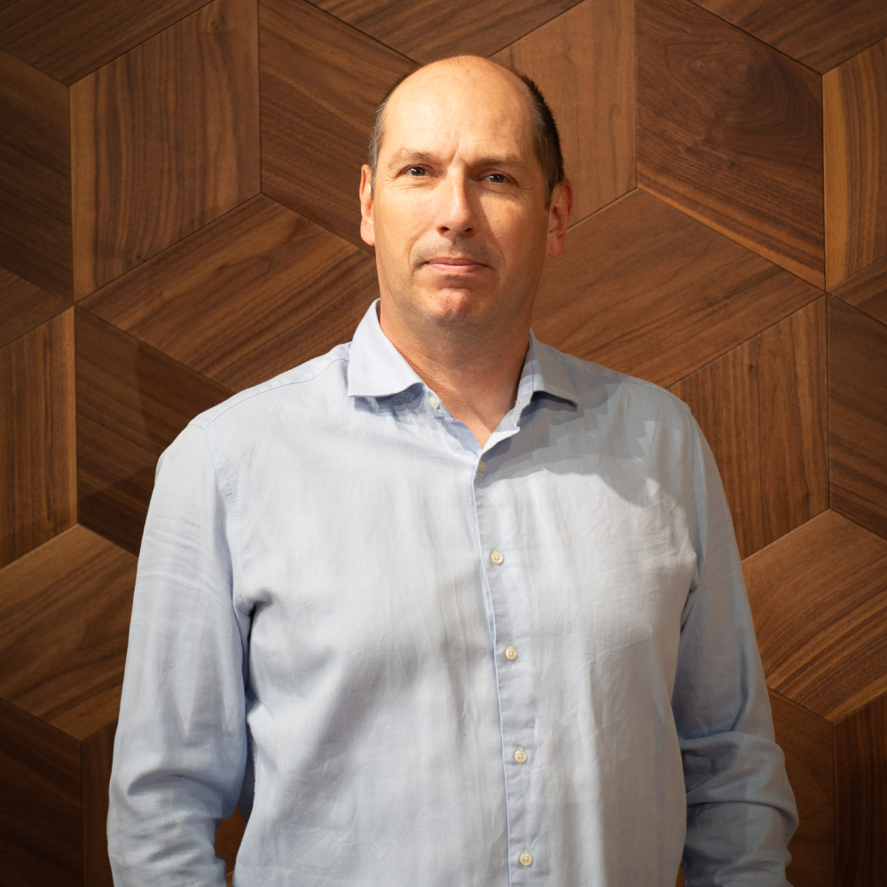 man stood in front of wood panelling